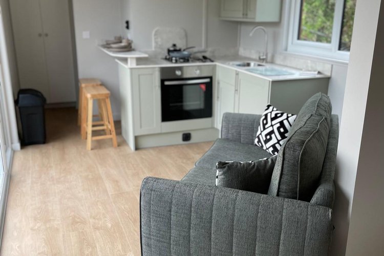 The living area inside a pod with cooking and sofas